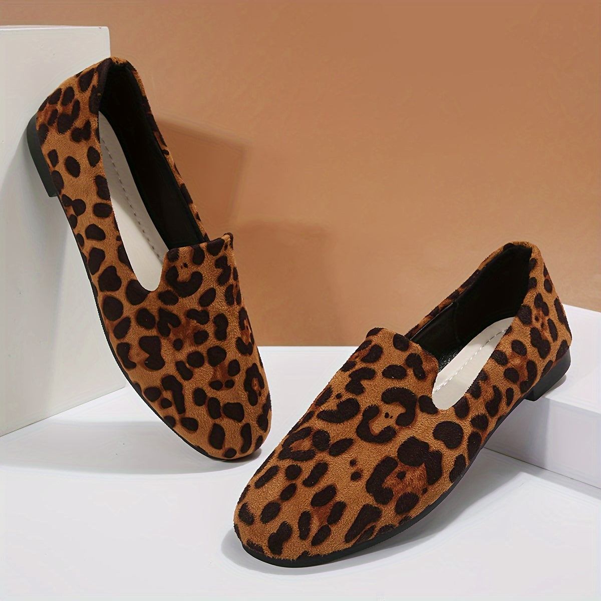 Leopard print women's flats with lightweight slip-on design, plain toe, fabric upper, and plastic sole - perfect for all seasons and versatile boat-style footwear.