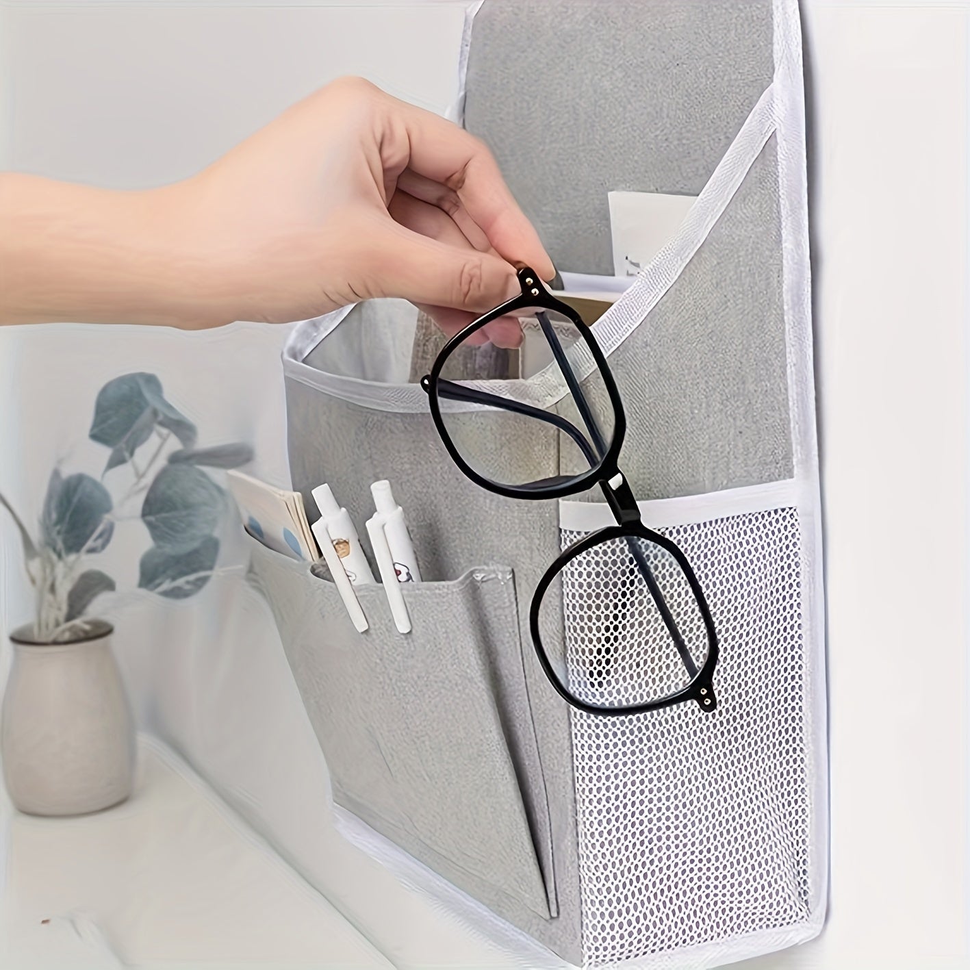 Wall-mounted storage organizer with dual pockets and mesh side compartment, ideal for dorms, wardrobes, homes, and offices. Comes in beige and grey, made of other materials.