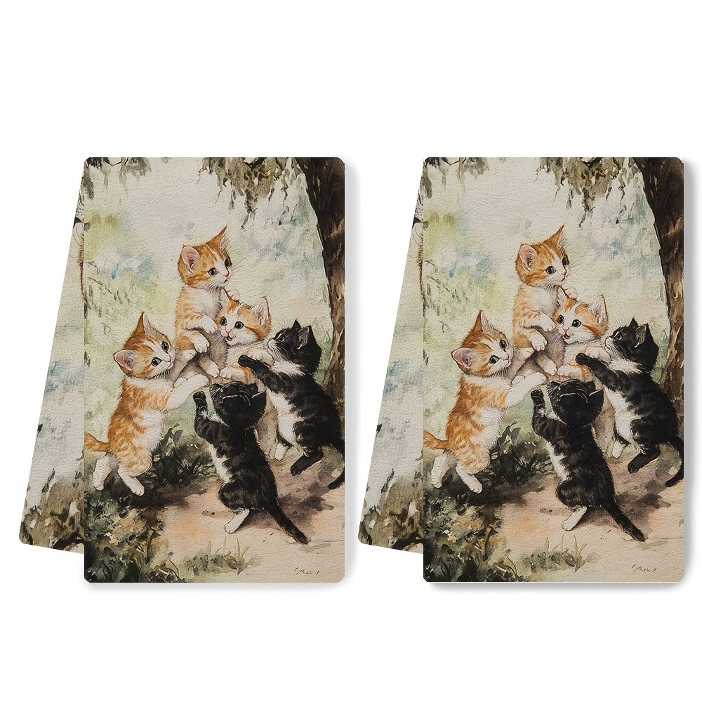 Two ultra plush kitchen towels featuring a playful kittens design. These highly absorbent towels are machine washable and measure 40.64x60.96 cm. Perfect for adding a touch of holiday charm to your kitchen decor and suitable for everyday use as dish