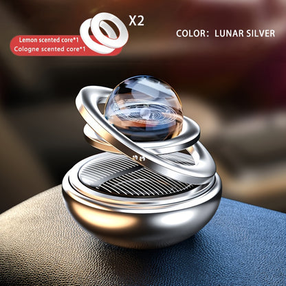 Solar rotating car aroma ornaments with solid perfume tablets for car interior decoration.