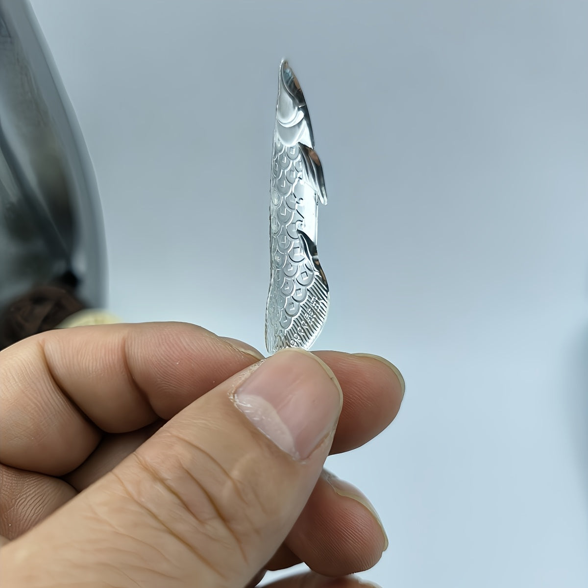 1 piece of silvery tea ceremony accessories for making tea and boiling water, a silvery dragon fish tea pet, and a silvery leaf for sterilizing and softening water quality.