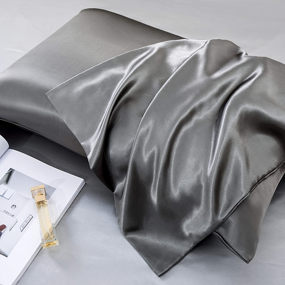 Two-pack of luxurious silky satin pillowcases, made from ultra soft smooth polyester with an envelope closure design. Available in solid colors, these machine washable pillow covers are lightweight at 80-85gsm, providing cooling comfort for hair and