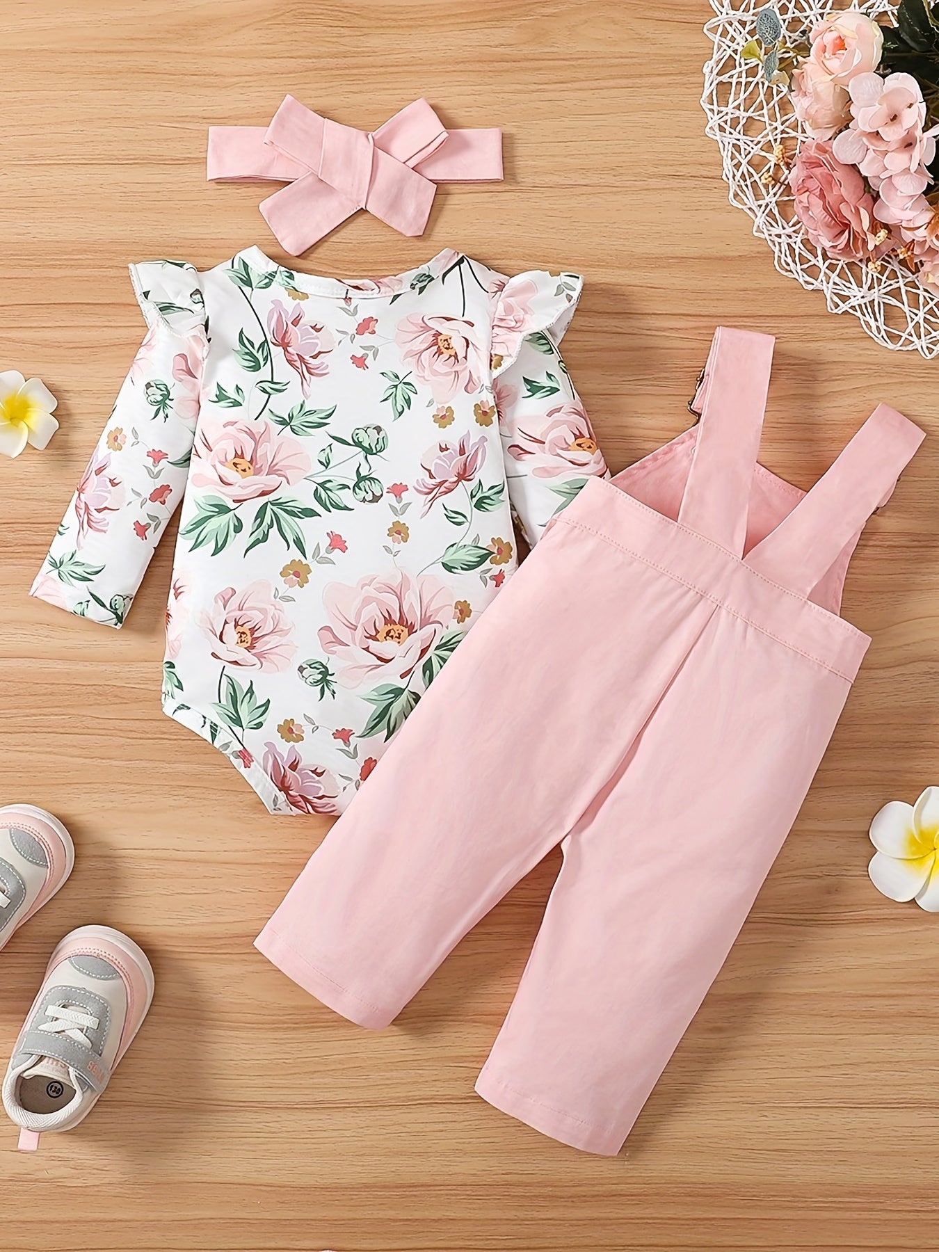 Girls 3-piece cotton set includes adjustable strap pants with pockets, floral print long sleeve romper with ruffle shoulder, and bow headband. Perfect for outdoor wear in spring/fall.