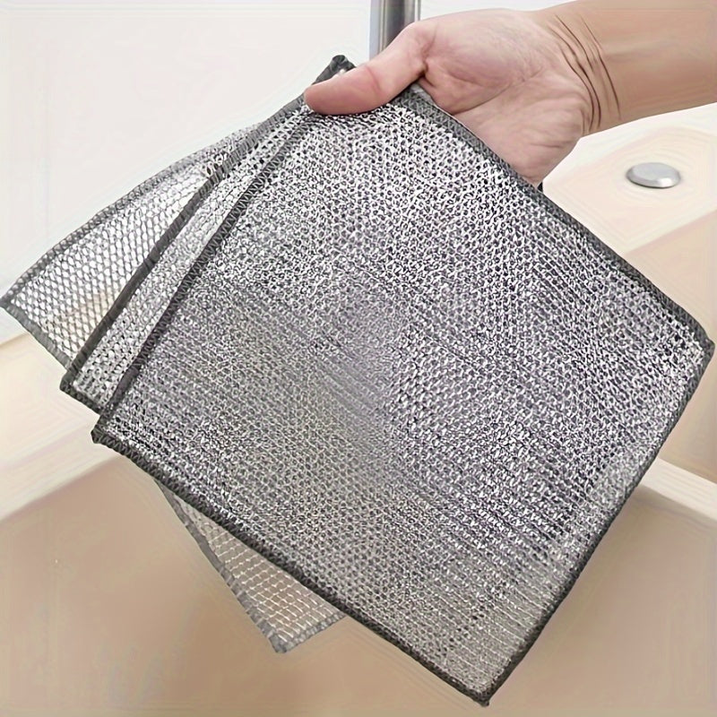 Kitchen scrubbing pads with a double-layer silvery edge are available in packs of 5 or 15. These scratch-resistant cloths can be used wet or dry for cleaning tableware, steel wire, and various surfaces such as bathroom doors and windows. The magic