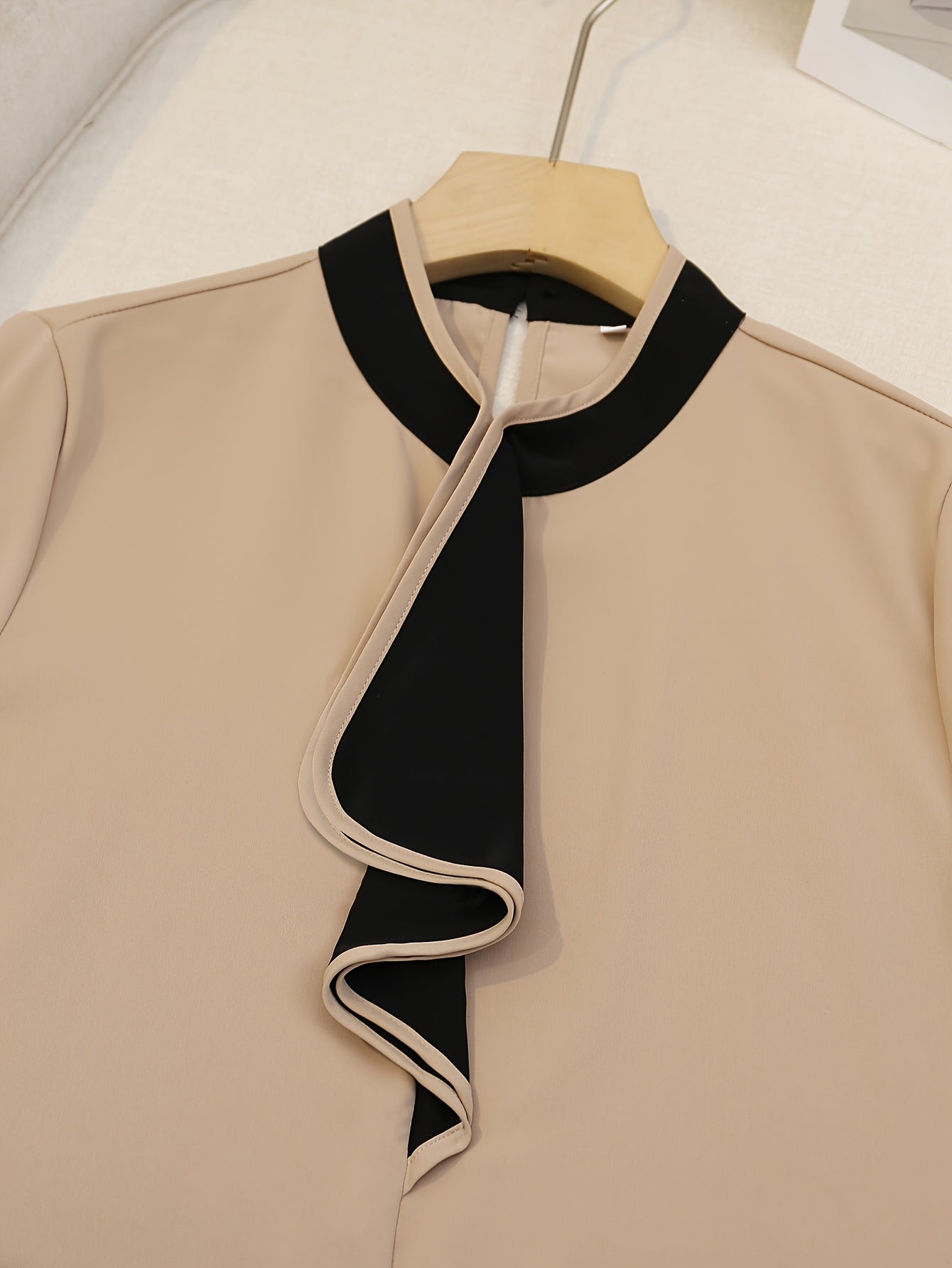 Women's beige blouse with black ruffle trim, contrast collar, long sleeve, made of polyester, machine washable, all-season chic top with tailored fit.