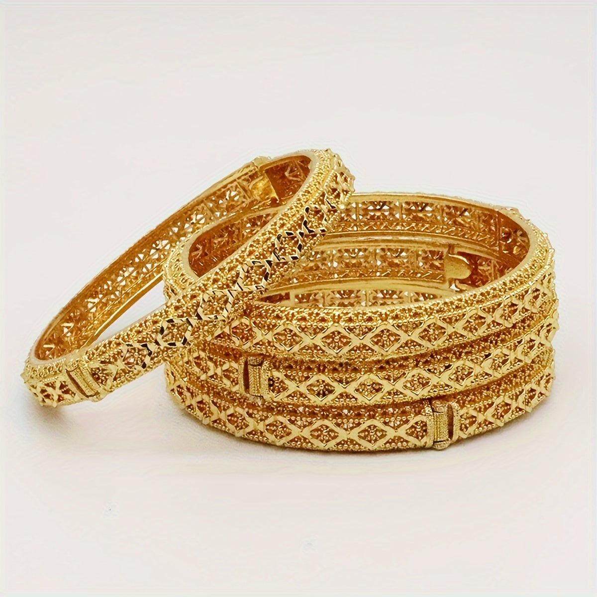 A set of four 24K golden plated bangle bracelets, luxurious and alluring zinc alloy jewelry inspired by Middle Eastern and African styles. Perfect for women to wear daily or to parties, music festivals, or as Ramadan gifts. Suitable for all seasons.