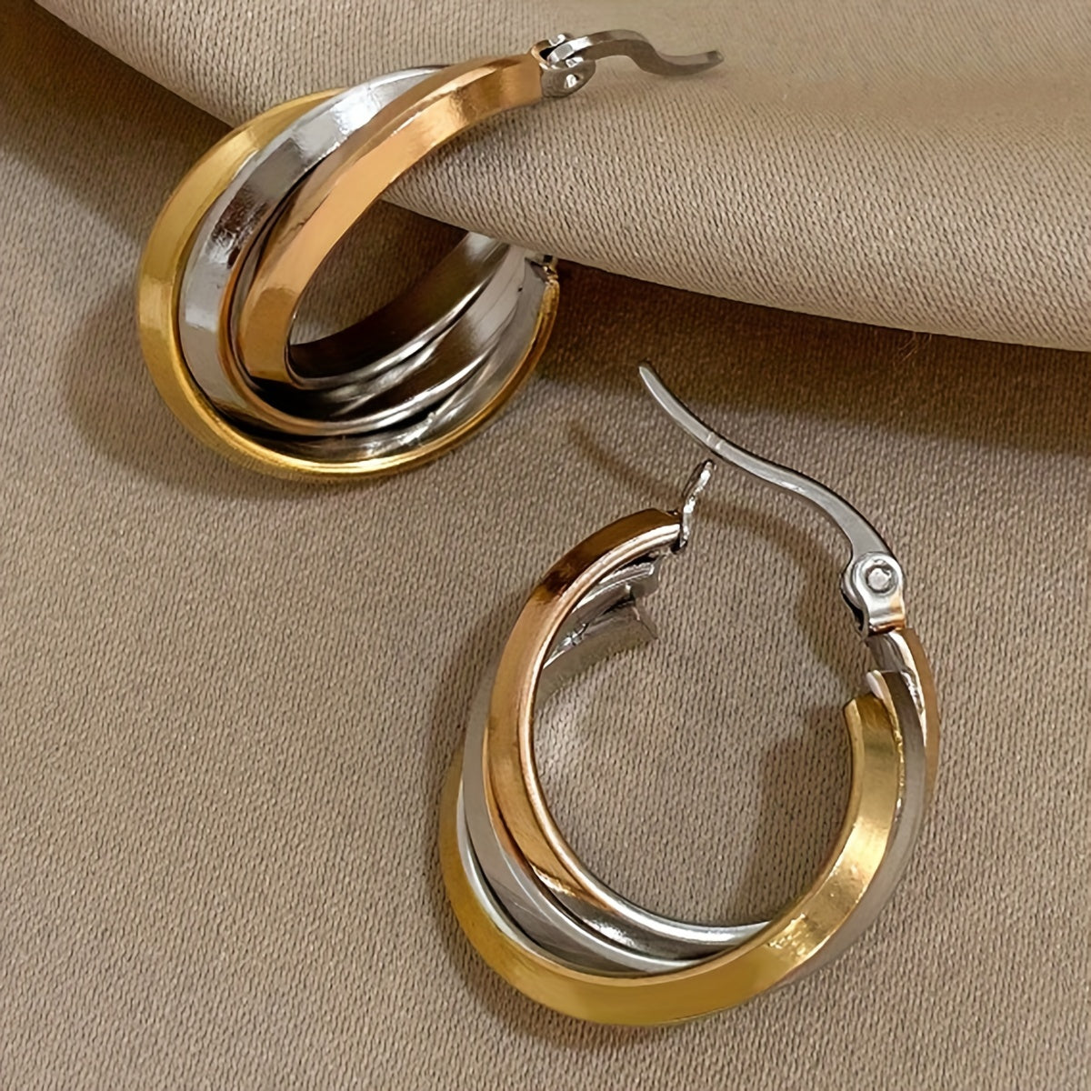 Multi-color twisted triple layered hoop earrings with a two-tone leverback design, perfect for adding a pop of color and style to any party, club, or vacation outfit. Give the gift of stunning jewelry to a loved one.