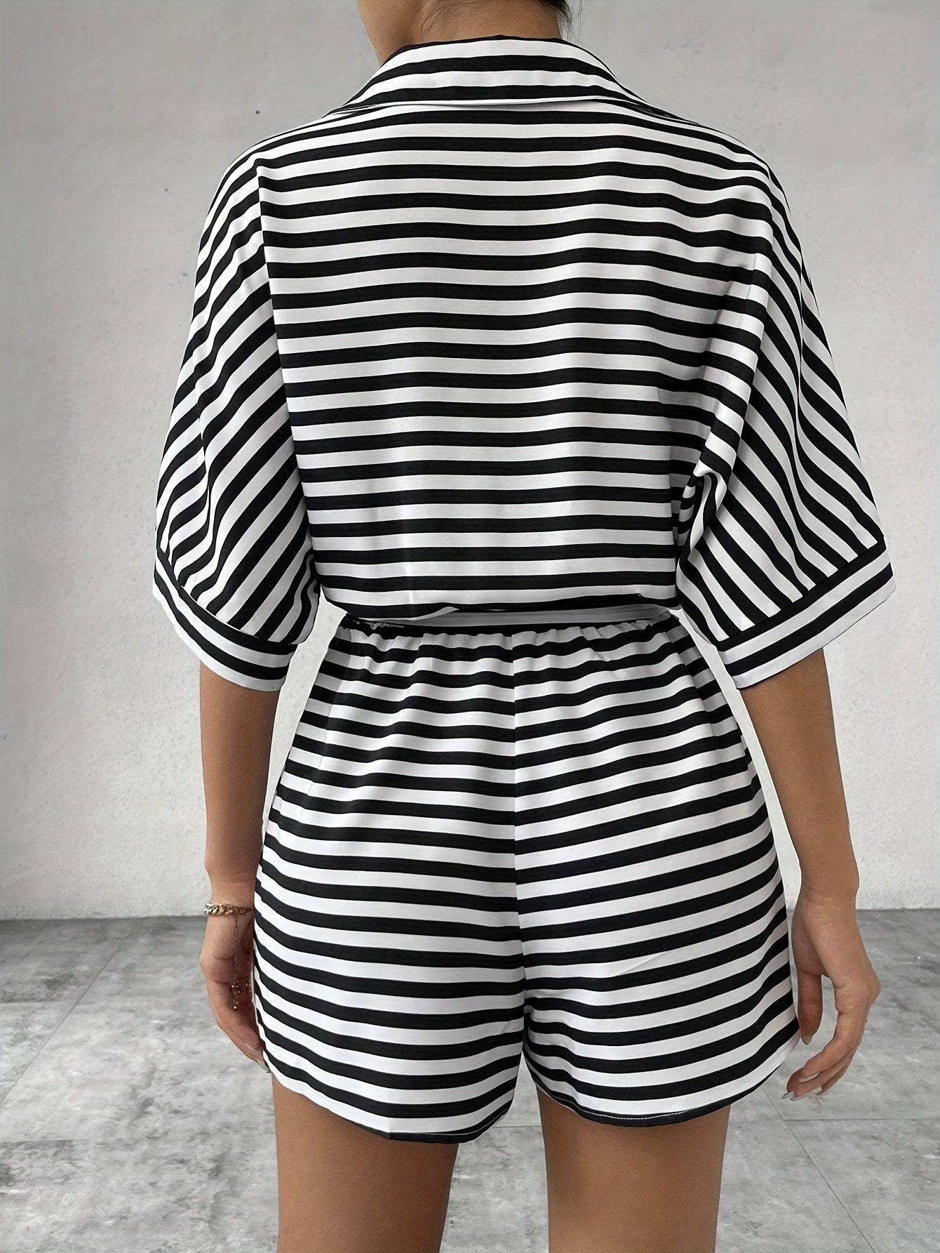 Button front romper jumpsuit with stripes, belt, short sleeves for spring and summer.