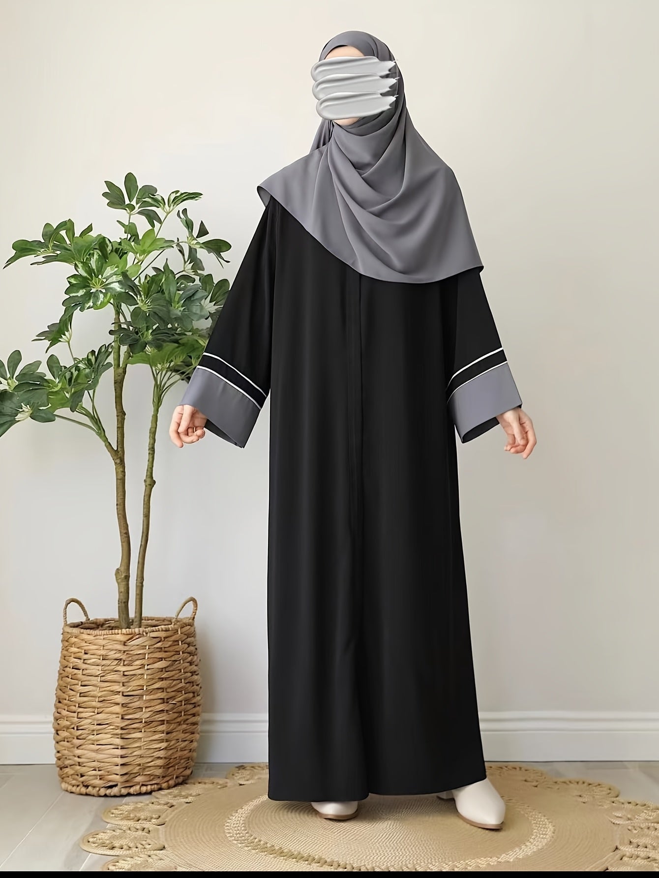 Elegant Black Abaya robe for Middle Eastern Muslim women with long sleeves and loose fit.