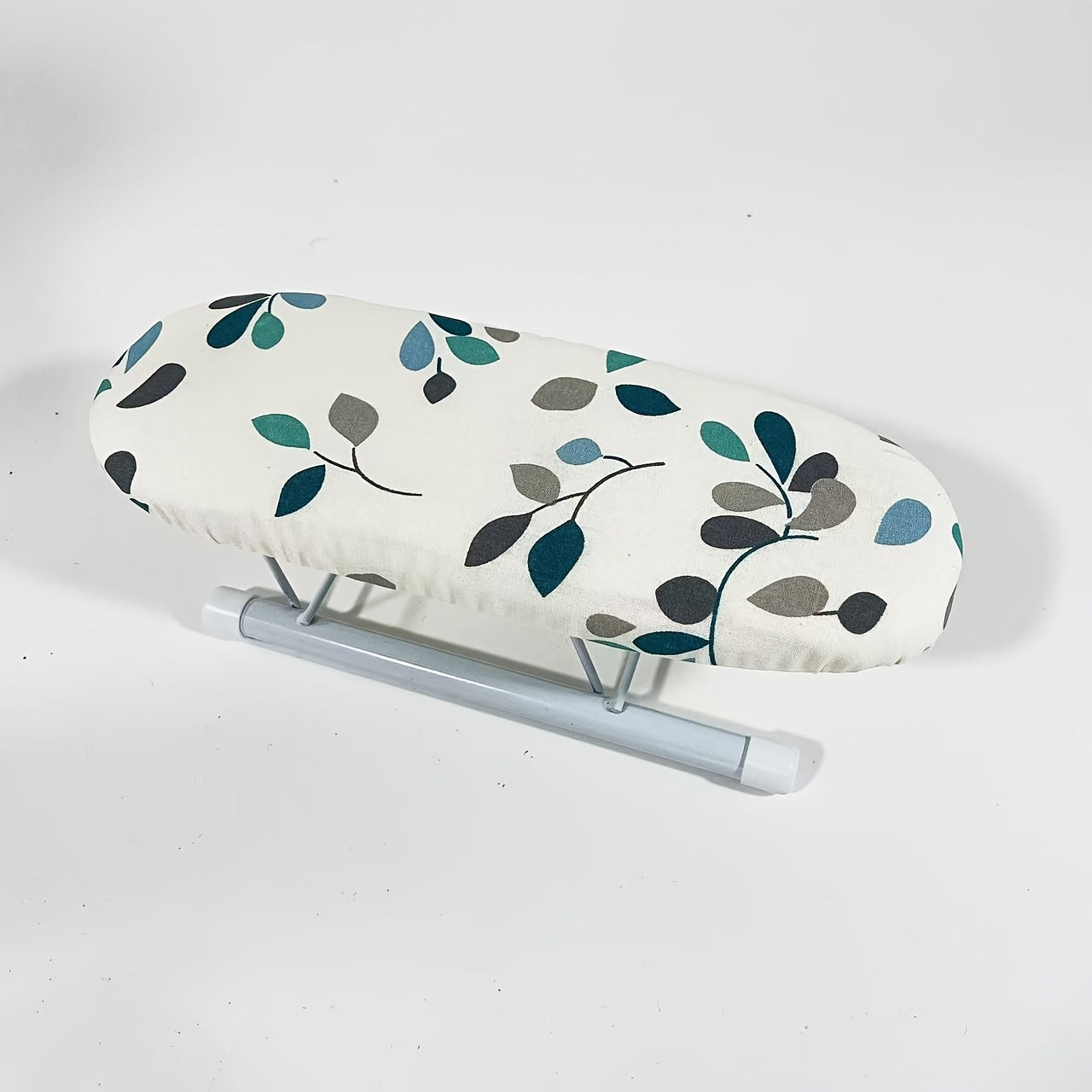 Portable mini ironing board featuring a leaf pattern, perfect for ironing sleeves and collars. Lightweight and easy to transport, no electricity or batteries needed.