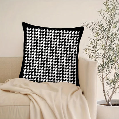 This reversible Contemporary Houndstooth Throw Pillow Cover measures 44.96cm and features a zipper closure. Made of woven polyester, this machine washable cushion case is perfect for living room decor. The black and white design adds a modern touch and