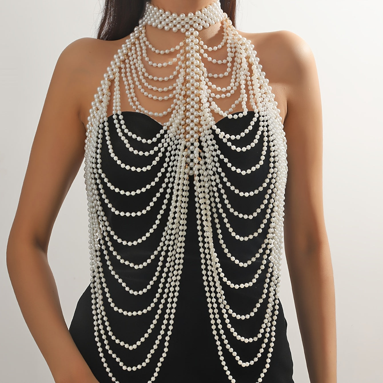 Luxurious and sexy, this female body chain features a creative design with exaggerated multi imitation pearl tassels, perfect for adding a touch of personality and style to any outfit.