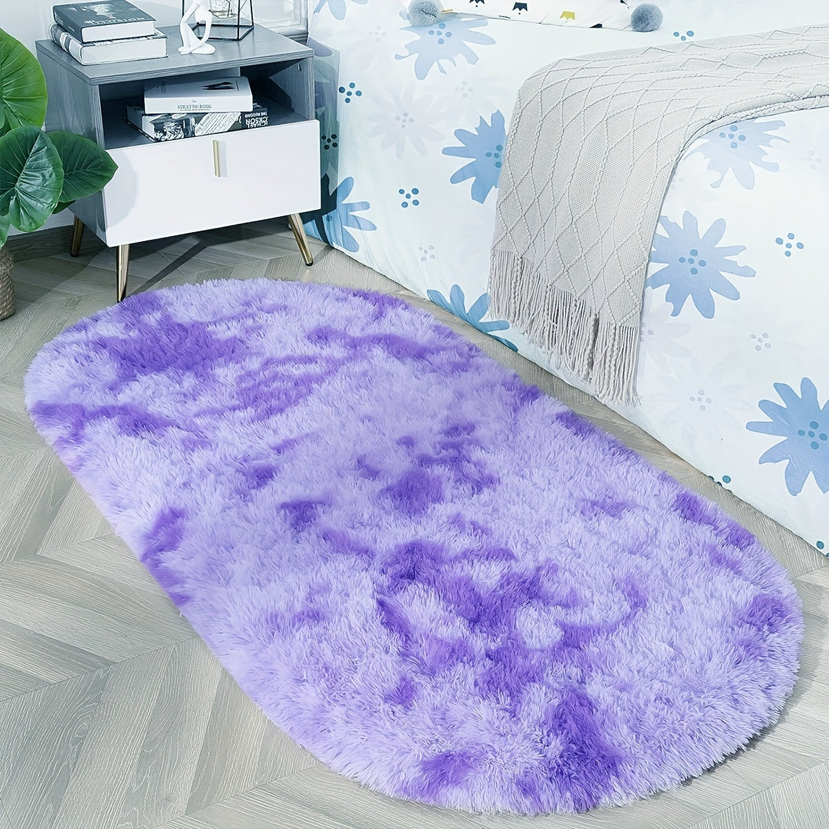 Soft and fluffy oval shaggy area rug, perfect for bedroom or living room. Made with skin-friendly thickened sponge and tufted polyester material. Durable and easy to maintain. Adds decorative touch to indoor spaces such as sofa, bedside, playroom, or