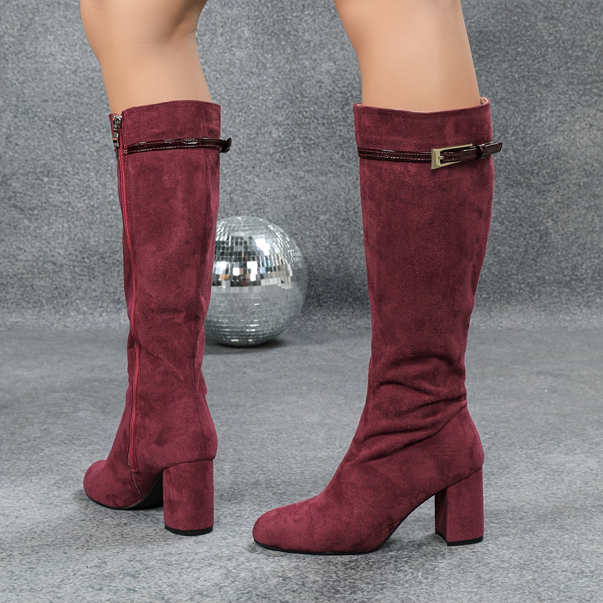 Burgundy side zip round toe knee-high boots with chunky heels.