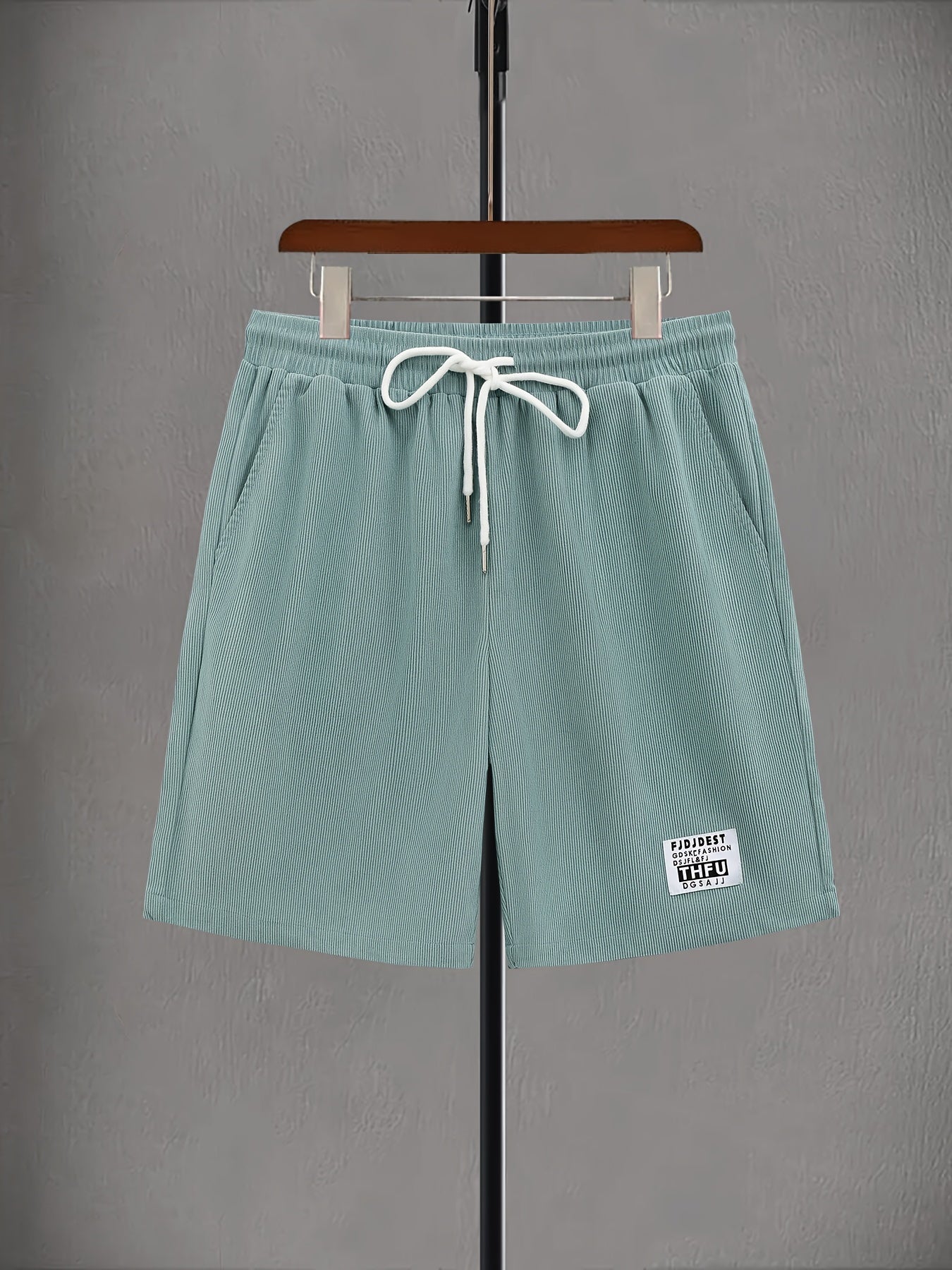 Plus size men's light green corduroy drawstring shorts with elastic waistband and pockets. Made of polyester fabric and machine washable. Perfect for summer.