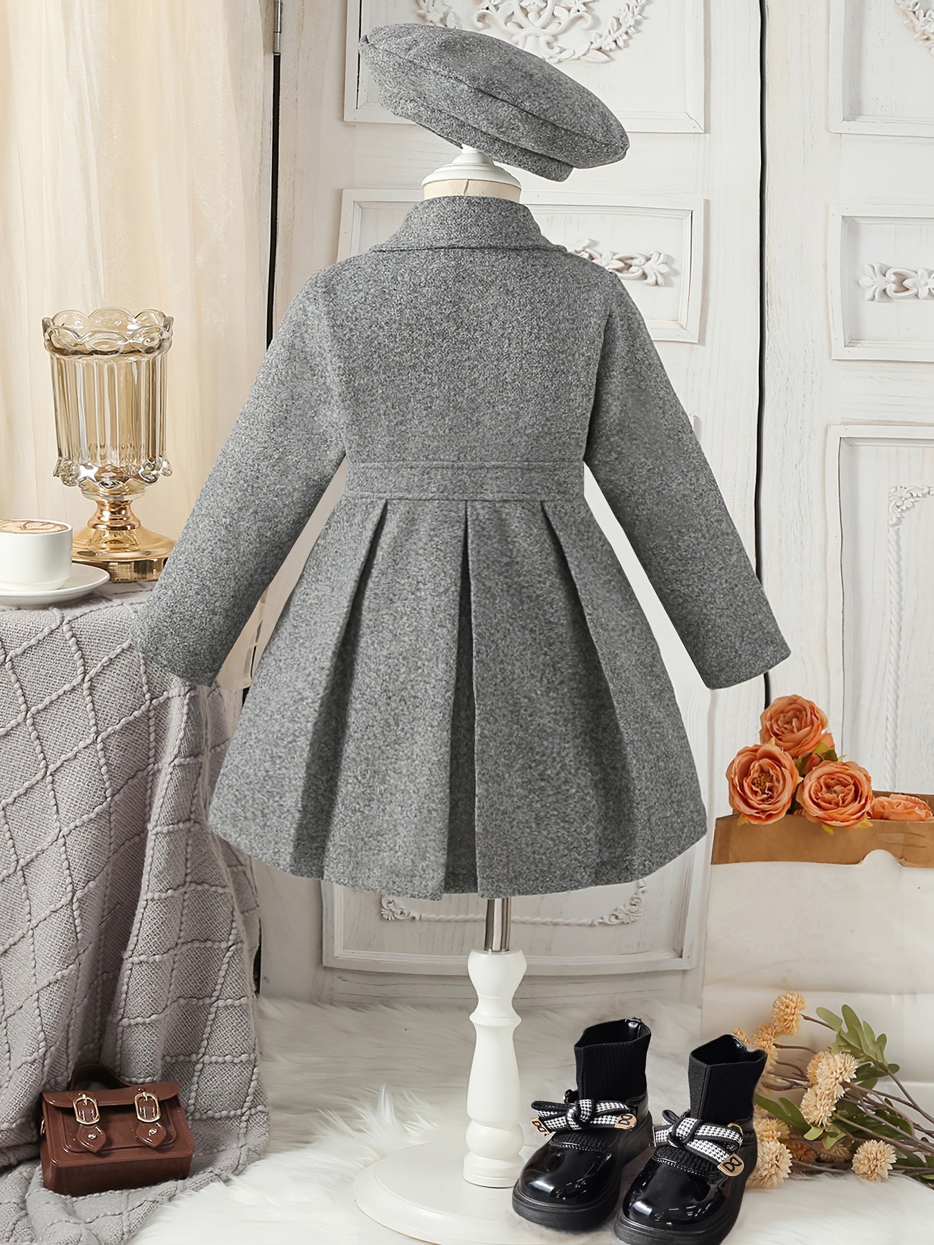 Youthful girls can look stylish in this casual polyester trench coat with lapel collar, double-breasted design, and matching bow detail and hat.