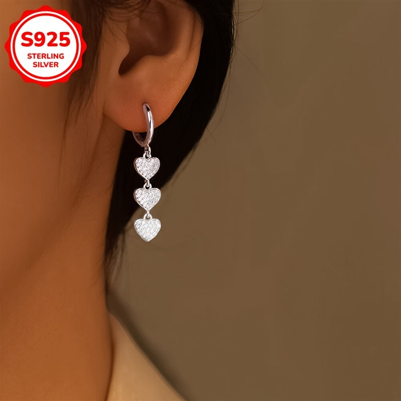 These exquisite ladies' earrings feature dazzling heart-shaped pendants embellished with synthetic zirconia, set in 925 silver. Weighing 3.6g, they are perfect for both daily wear and special occasions such as banquets.