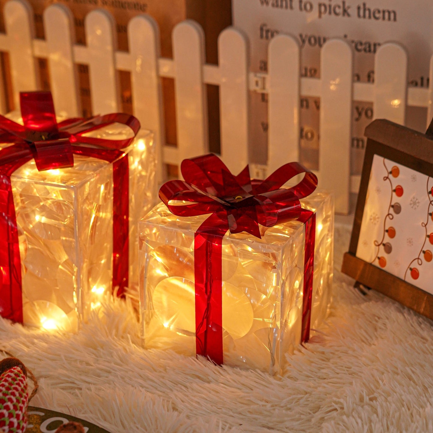 Set of 3 Christmas lighted gift boxes with warm white transparent lights and red bows for outdoor Christmas decorations.