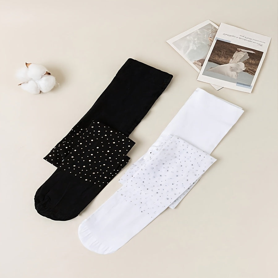 2 pairs of black and white rhinestone-studded tights for baby girls.