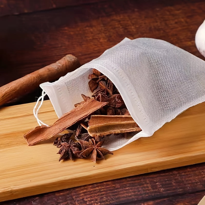 100 pieces of disposable tea filter bags made of plastic with drawstring, designed to be filled with loose leaf herbs and spices for infusion.