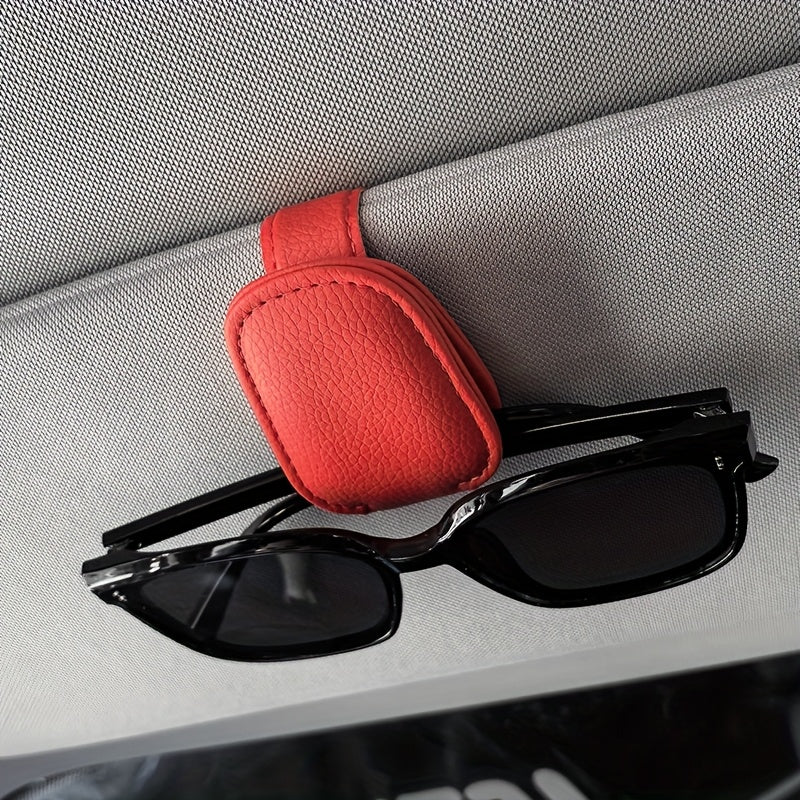 Universal car sun visor clip made of PVC material for storing eyeglasses in the vehicle interior.