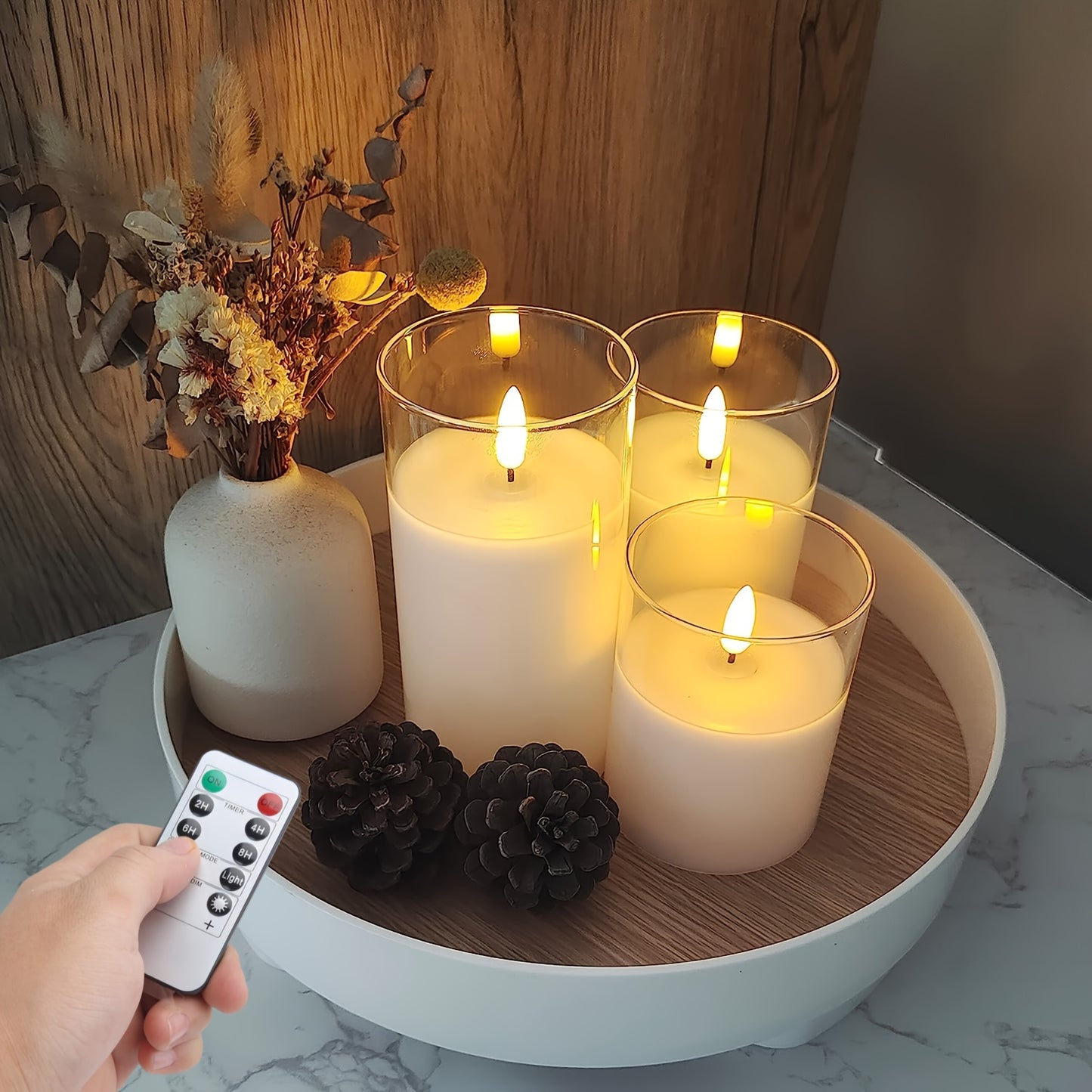 Remote controlled LED candle set with battery operated candles in three different sizes (10.16cm, 12.7cm, 15.24cm) and timer function. Ideal for home decor, parties, and festive occasions.