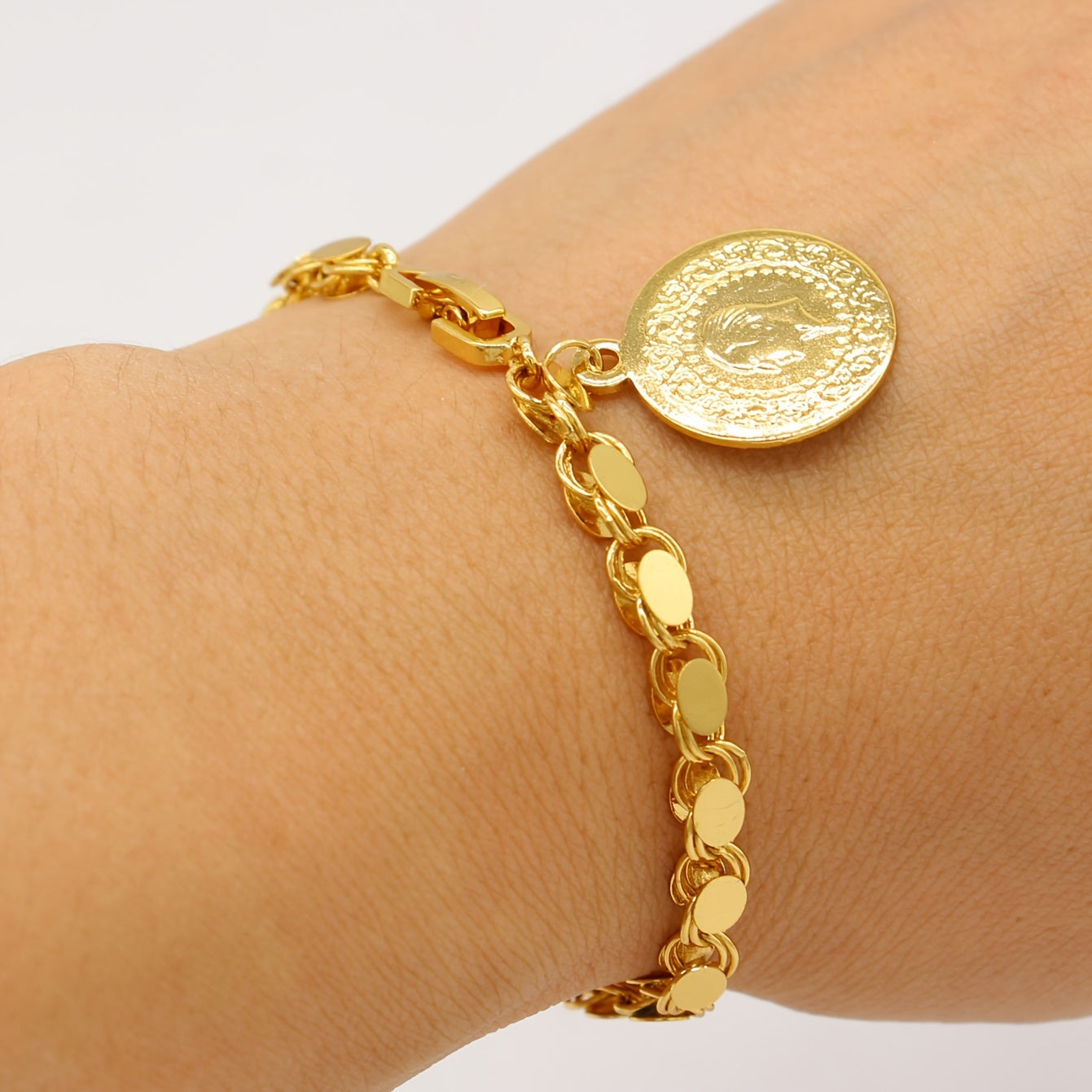 A handmade bracelet adorned with a gold-plated Turkish lira pendant, perfect for everyday or special occasions.