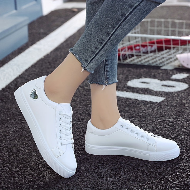 Stylish women's casual sneakers with heart-shaped design, lace-up style, and flat white soles - ideal for leisure wear.