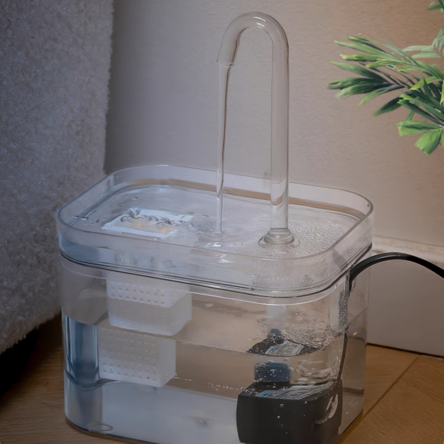 Transparent USB-powered automatic pet water fountain for indoor dog and cat hydration.