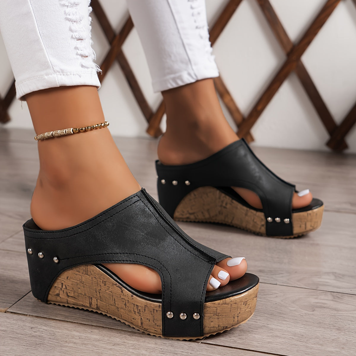 Women's platform sandals with studded decor and wedge heel.