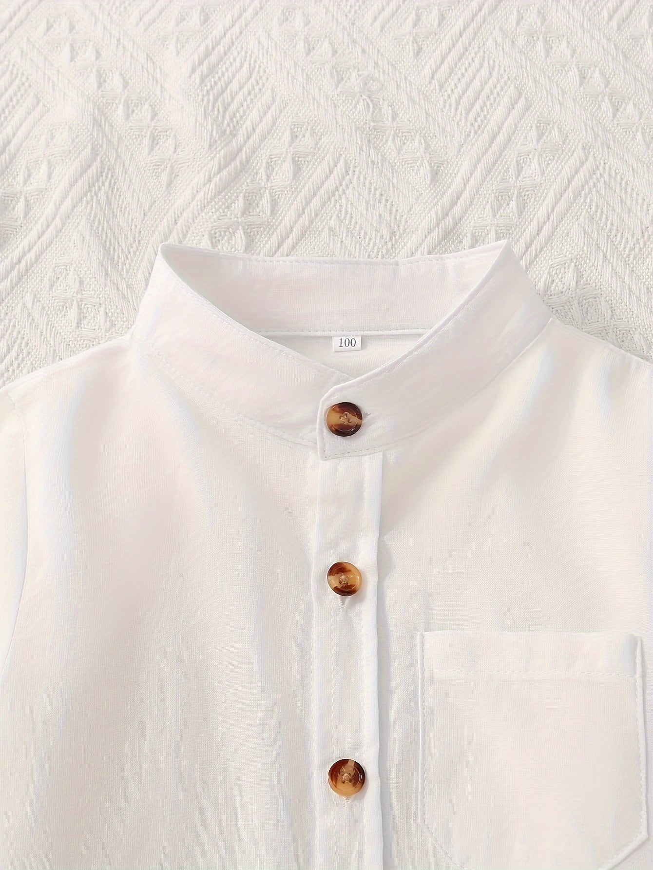 2 boys solid color stand collar shirts with long sleeves and button-up design, suitable for spring and fall wear.