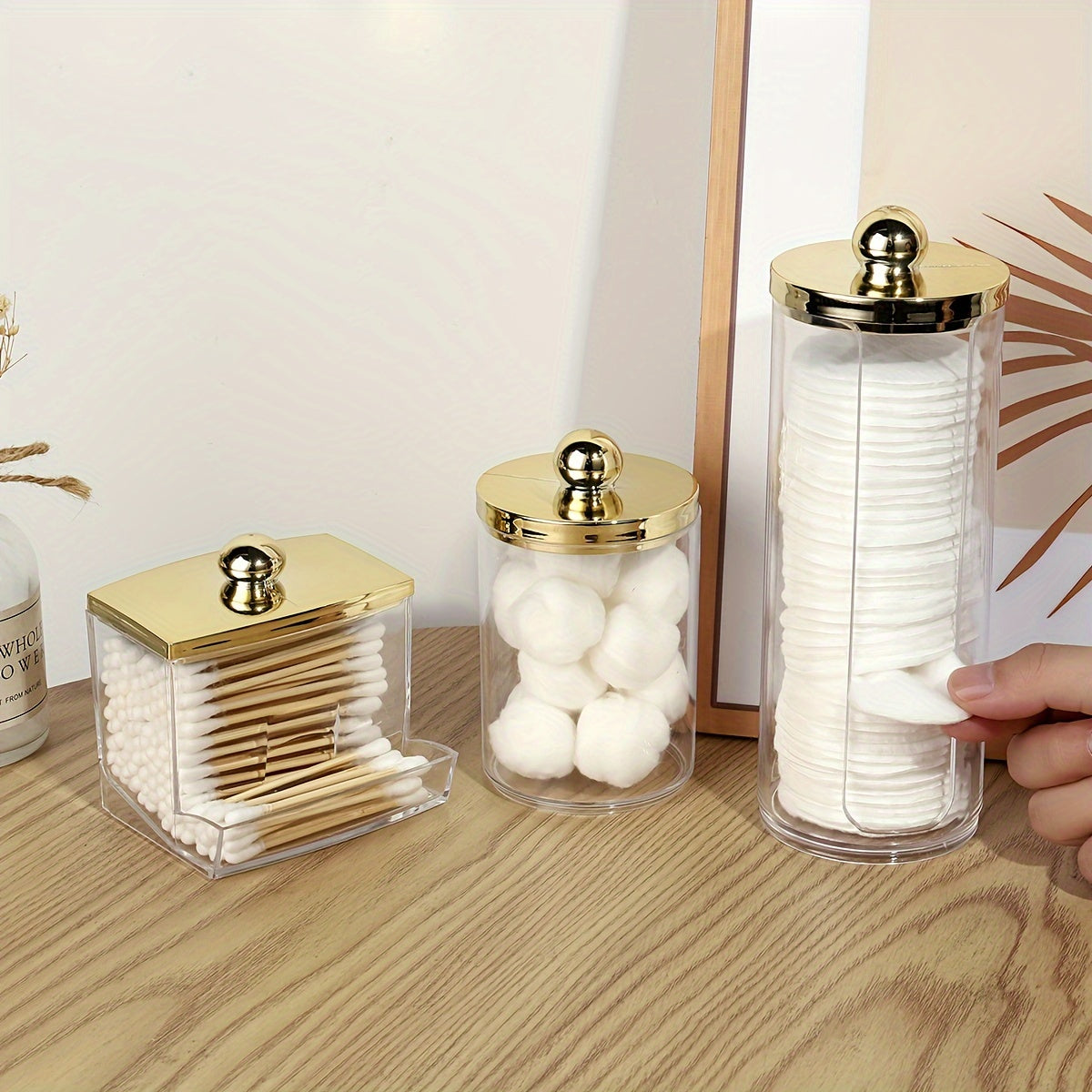 Bamboo-lidded cotton pad holder for bathroom organization.