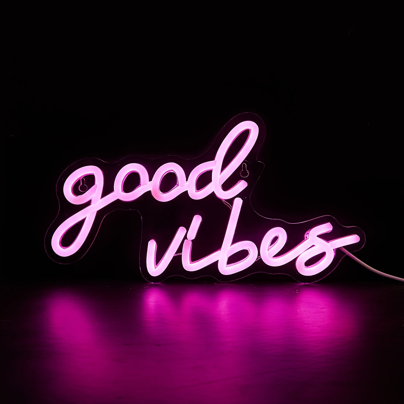 Pink cursive "Good Vibes" LED neon sign, USB powered for wall decor in bedroom, bar, or party atmosphere.