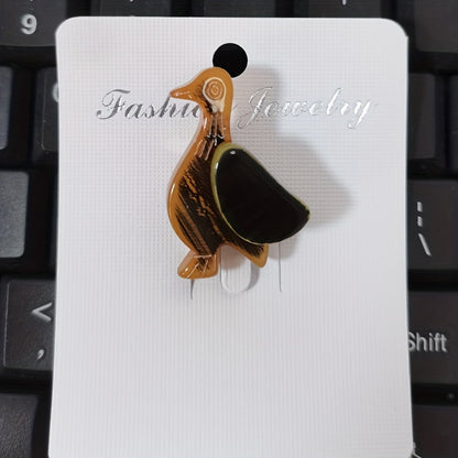 Animal-shaped acrylic duckling brooch pin with color block design is a cute fashion accessory for collars and clothing.