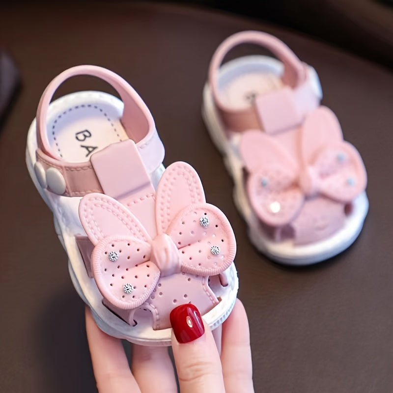 PVC low-top shoes for kids with cartoon and floral pattern, buckle closure, and soft sole.