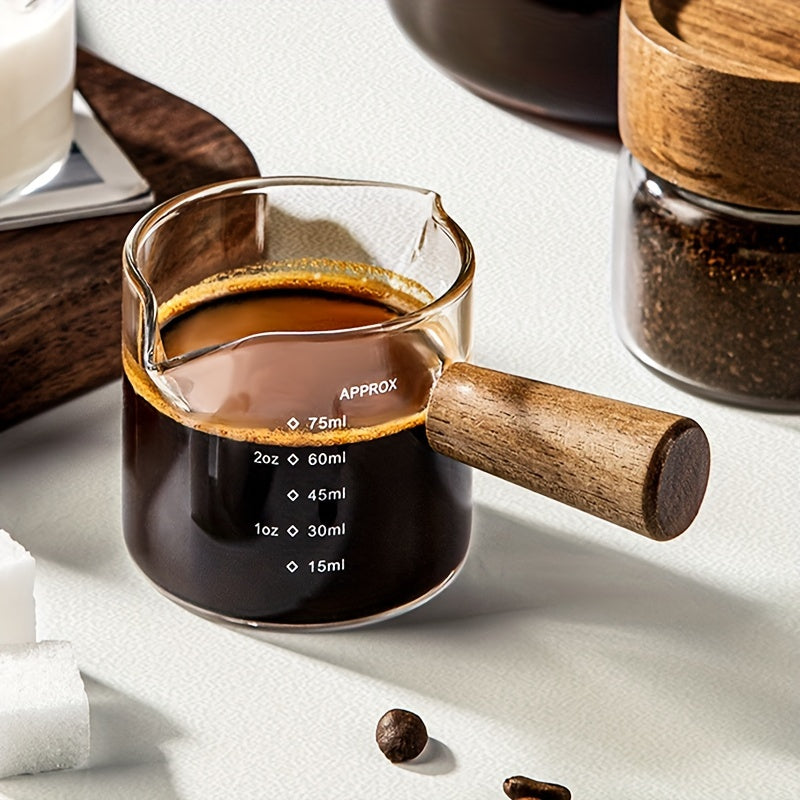 Small and stylish, this 2oz measuring cup features a heat-resistant glass body and a convenient wooden handle for easy use. With dual spout, scale markings, and ideal for measuring small quantities, this cup is perfect for both coffee and kitchen use.