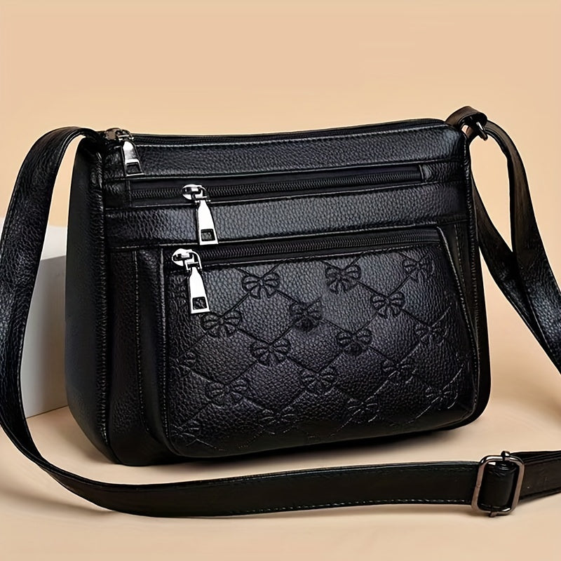 Trendy black crossbody bag for women with adjustable strap, floral design, and zipper closure, ideal for daily use.