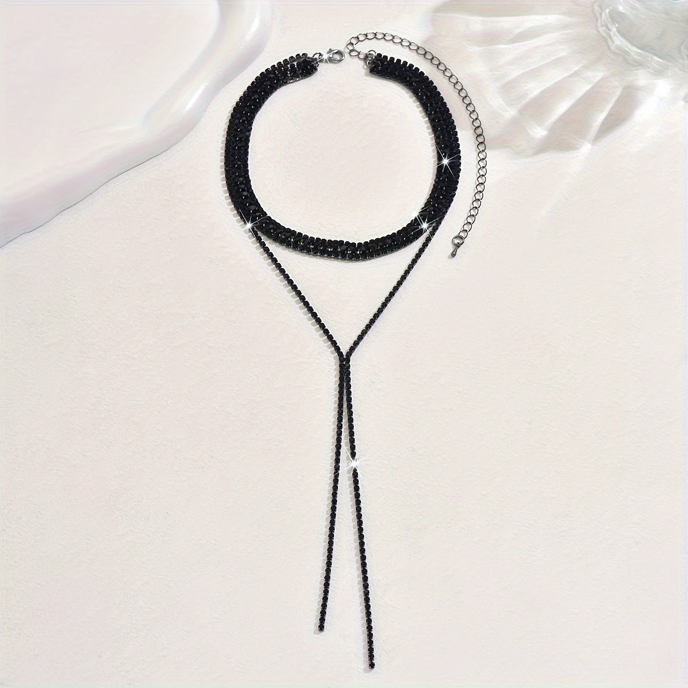 Elegant and luxurious, this black and white tassel necklace features shiny rhinestones, making it the perfect accessory for bridal events and weddings. Delicate and stylish, this multi-layer necklace is an ideal gift for any occasion.