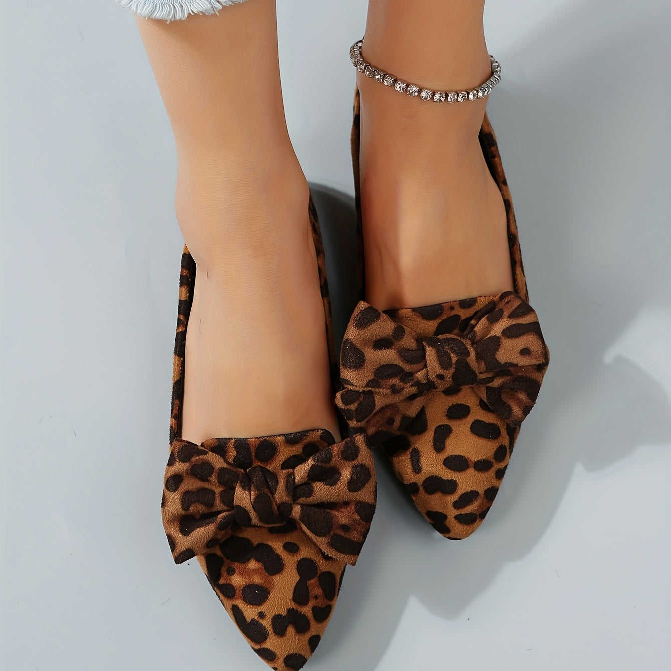 Leopard print flat shoes with bowknot decor and point toe, lightweight slip on style.