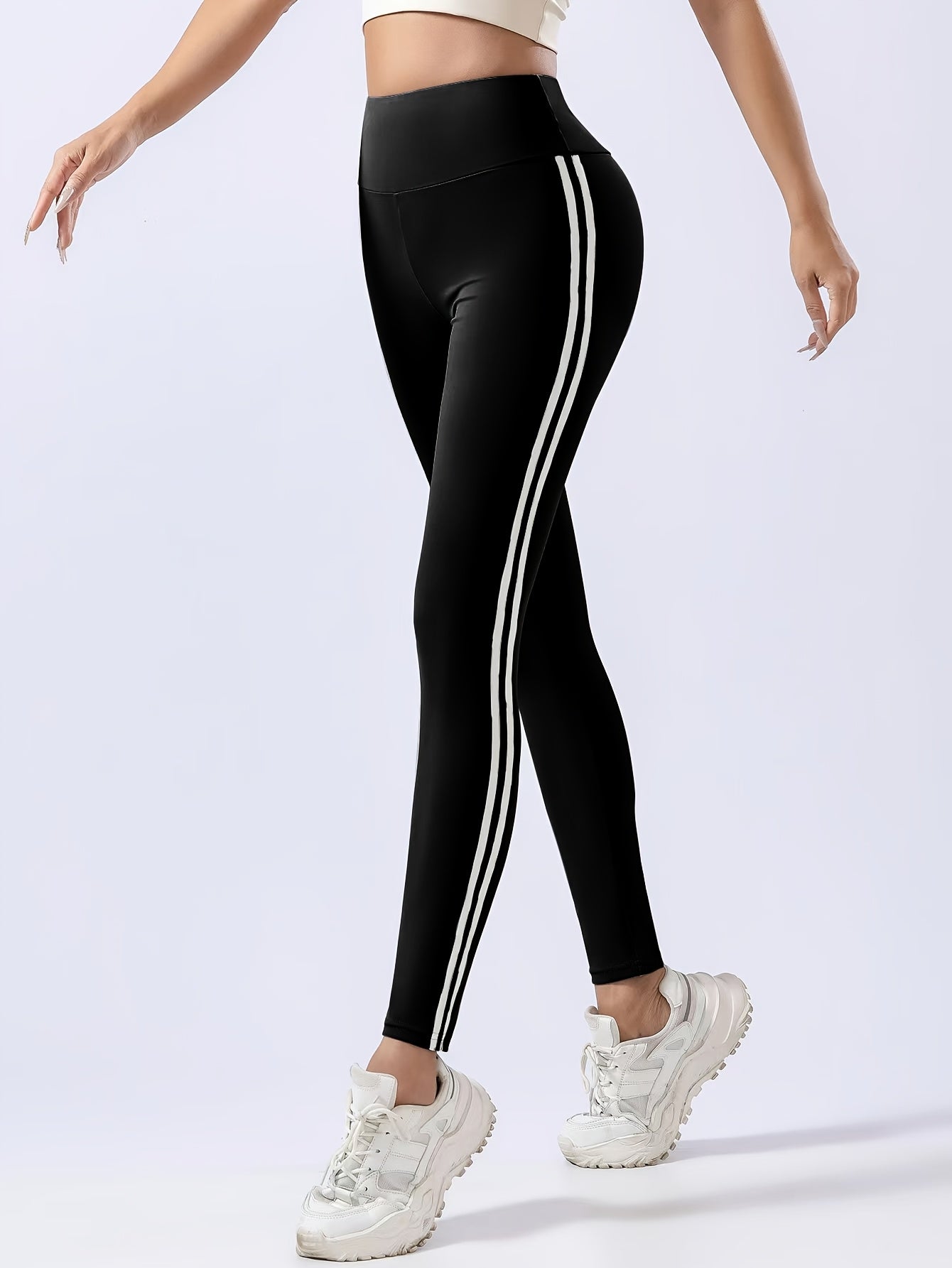 Women's chic black leggings with white side stripes, high-waist design, butt lifting, and tummy control features. Made with quick-dry and breathable fabric for a slimming effect. Machine