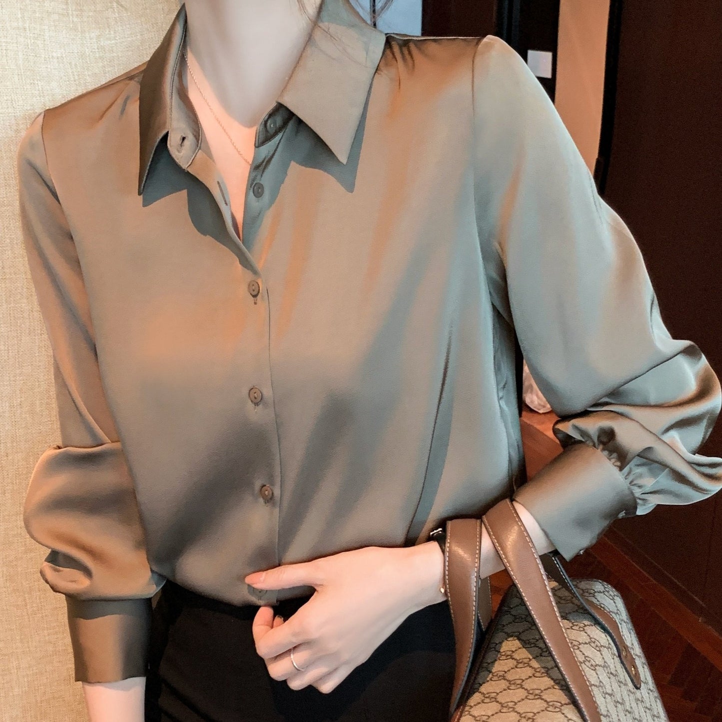 Women's chic solid color long sleeve blouse made of 100% polyester with lapel collar and button details. Suitable for all seasons.