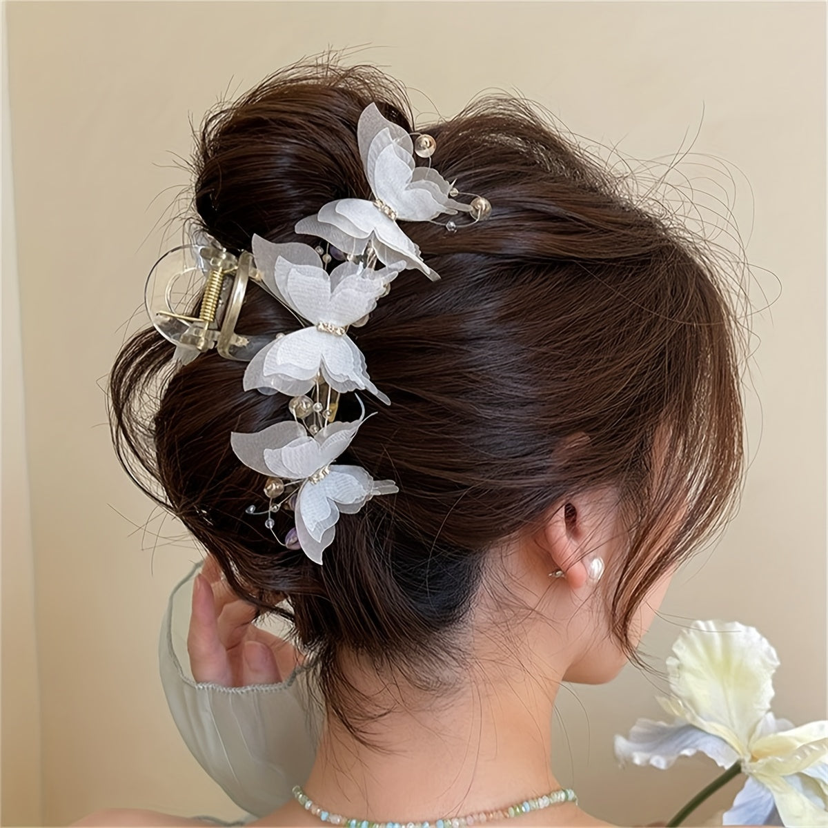 Stylish golden butterfly hair clip with crystal beads - perfect for chic updos & buns.