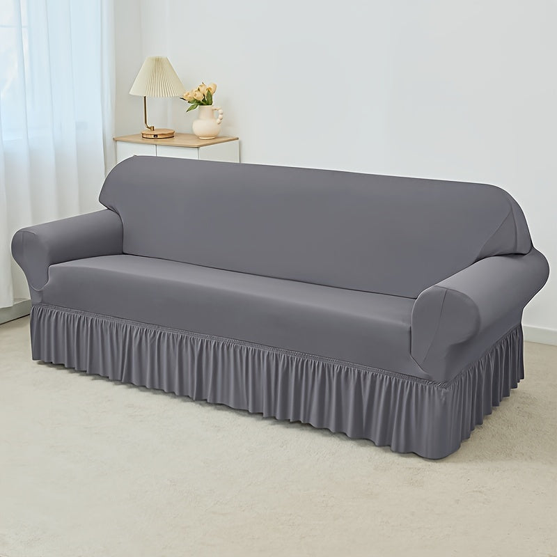 Elastic waterproof sofa slipcover with skirt for all seasons, ideal furniture protection for home and office.