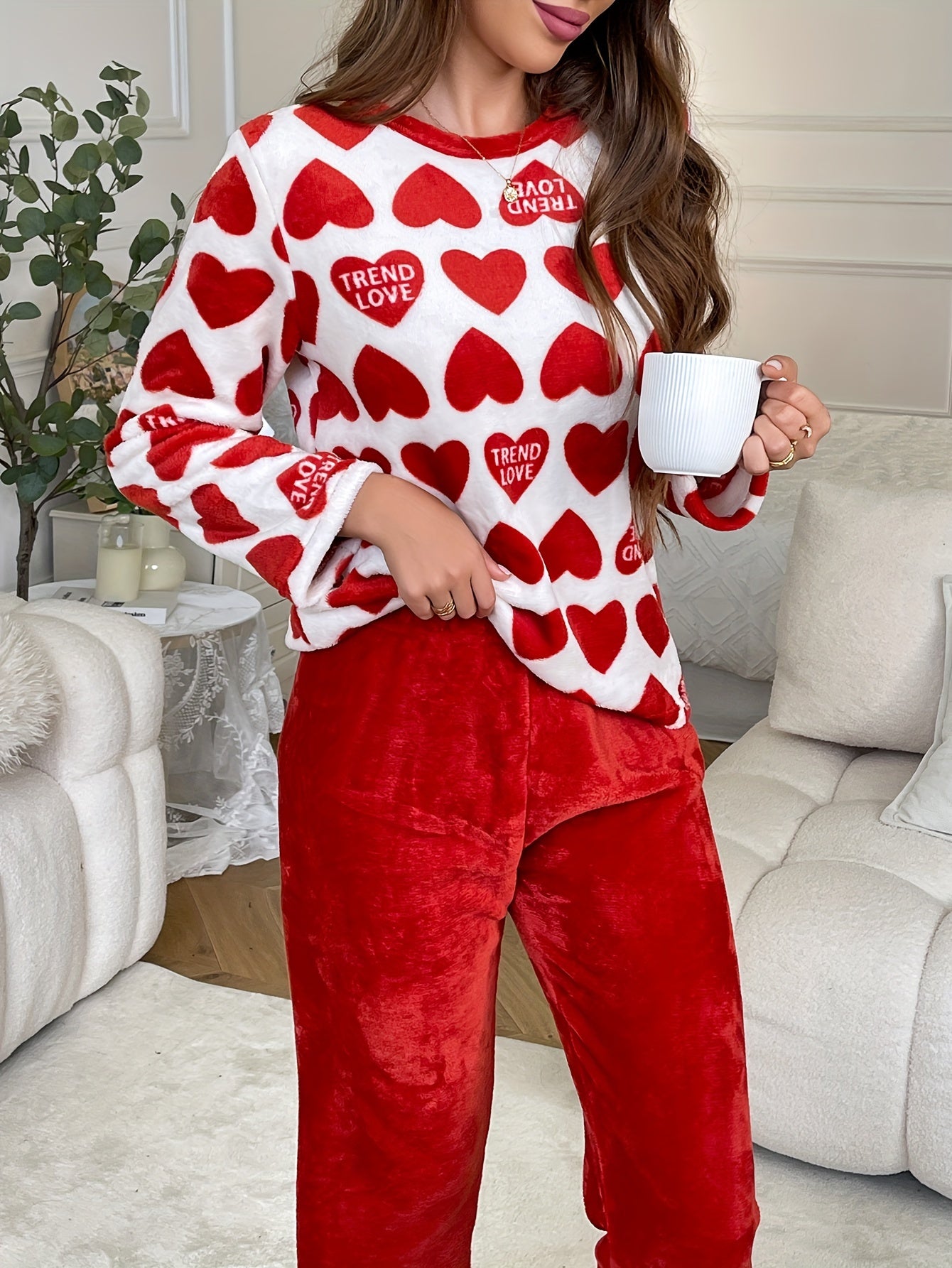 Cozy lounge set for women featuring heart and letter print, perfect for fall and winter. Includes long sleeve top and pants with a relaxed fit.