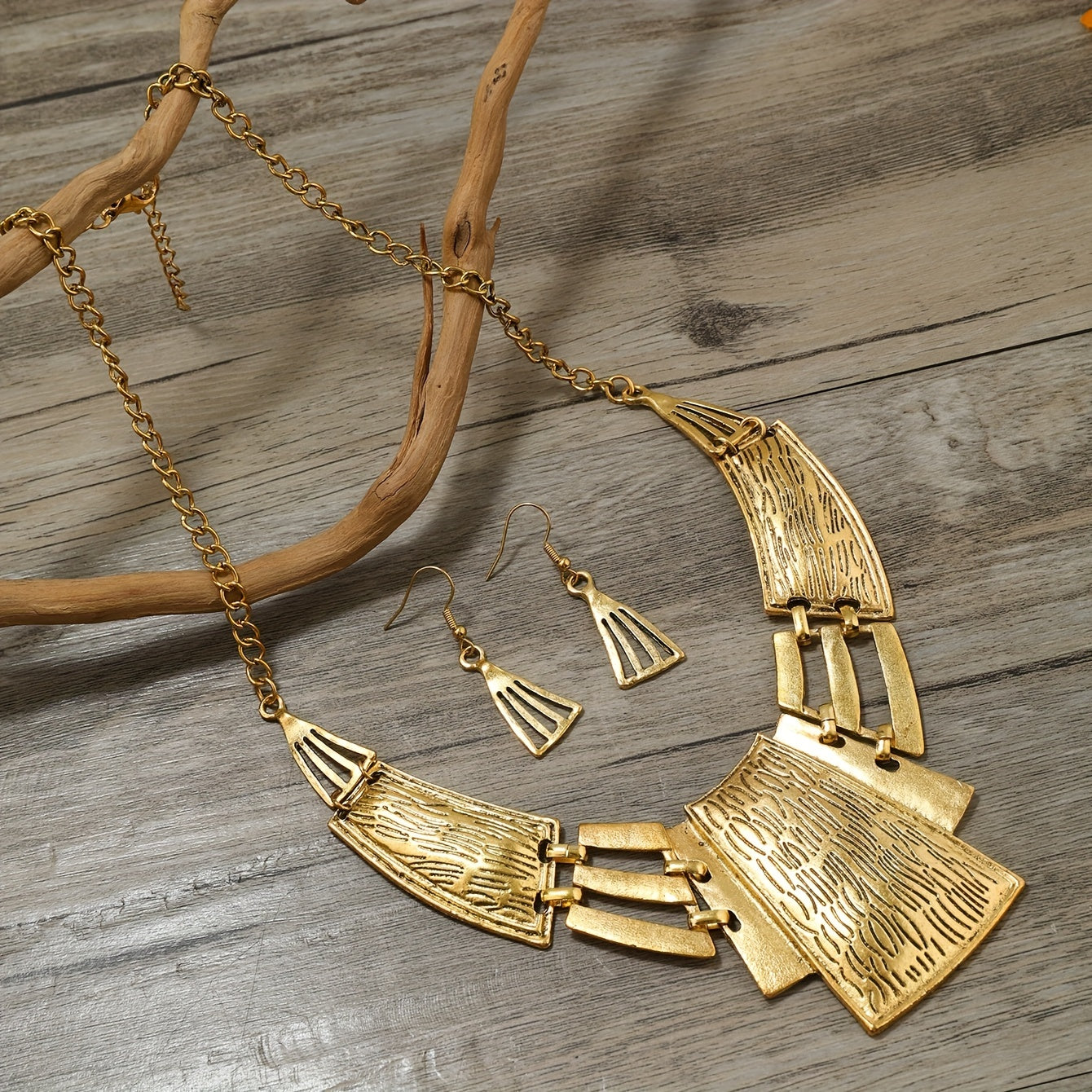 Vintage Jewelry Set includes 3 pairs of earrings and a necklace, featuring a geometric design in either silvery or golden tones. Choose the one that suits your style and make a stunning statement with these party accessories.