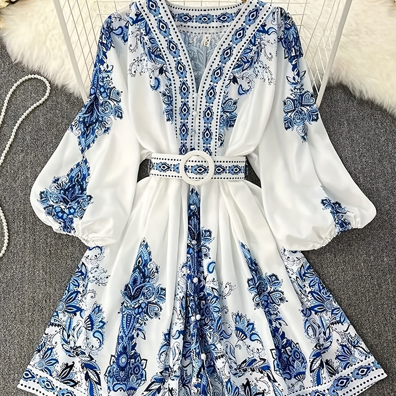 Bohemian floral print midi dress with belt, perfect for summer vacations and casual wear. Made of lightweight polyester with a V-neck and half sleeves.