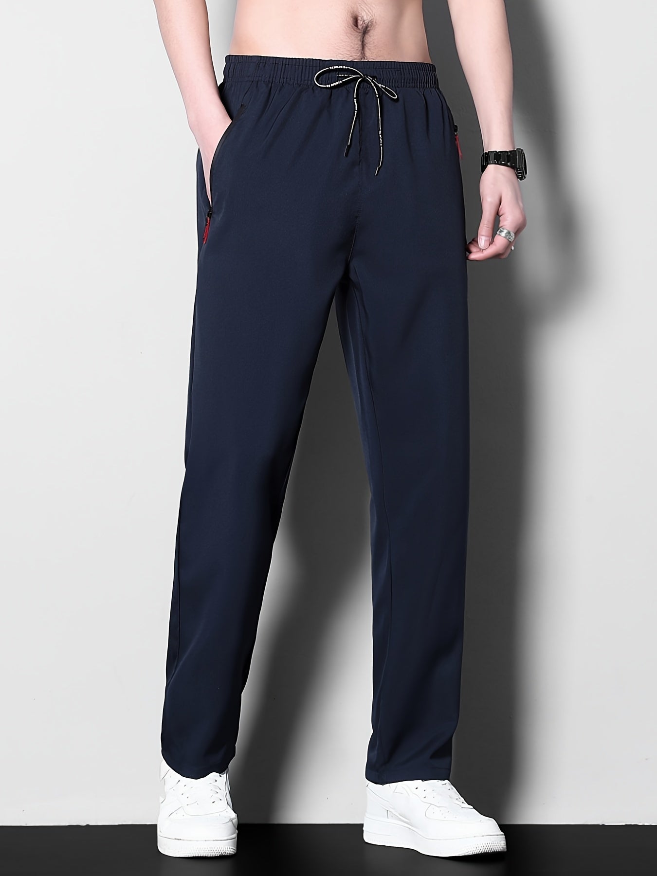 Men's plus size casual sports pants, made of stretchy polyester in a solid color with a regular fit, zipper detail, part of the spring/summer collection.