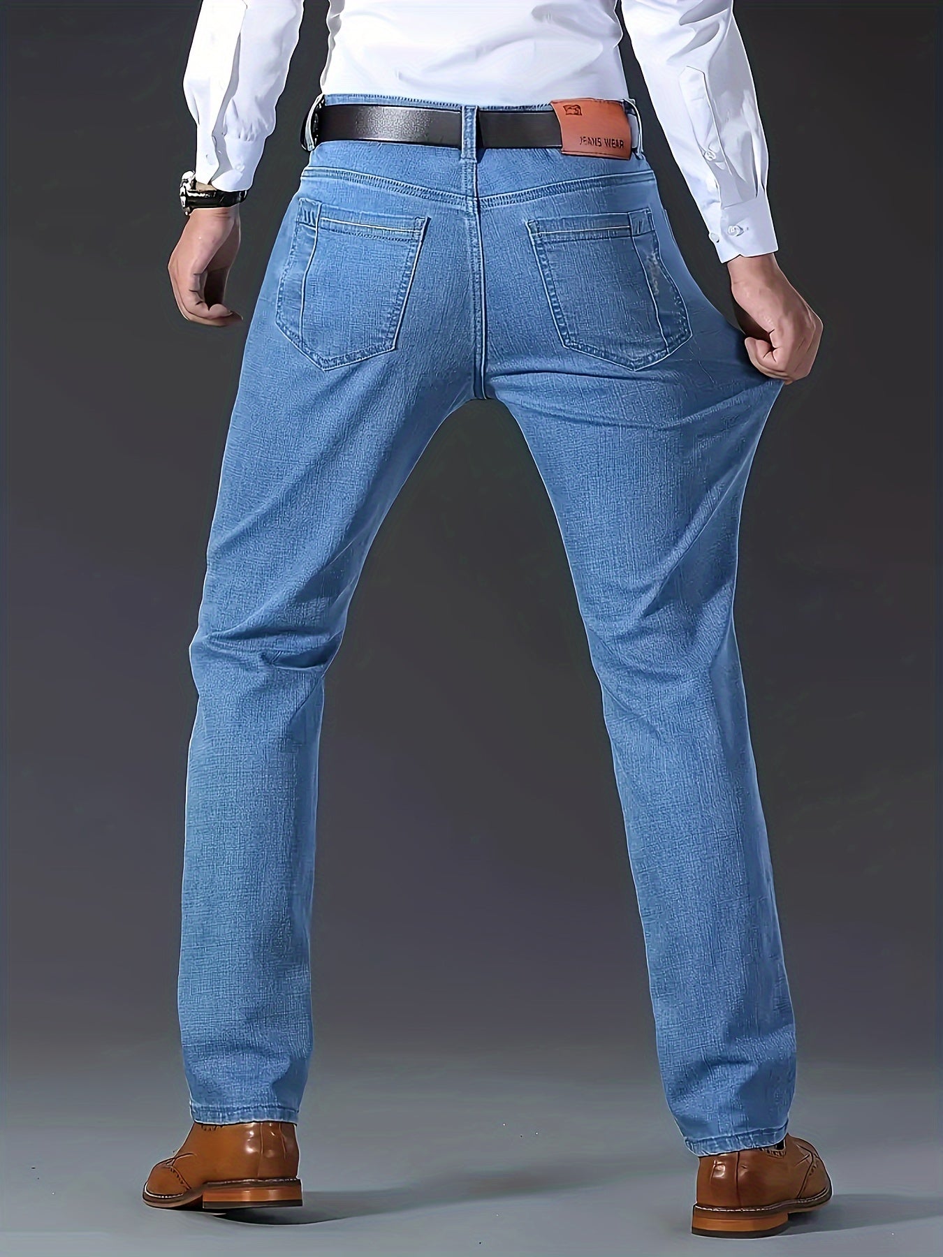 Casual solid denim pants for men with pockets, made from a cotton blend for outdoor activities.