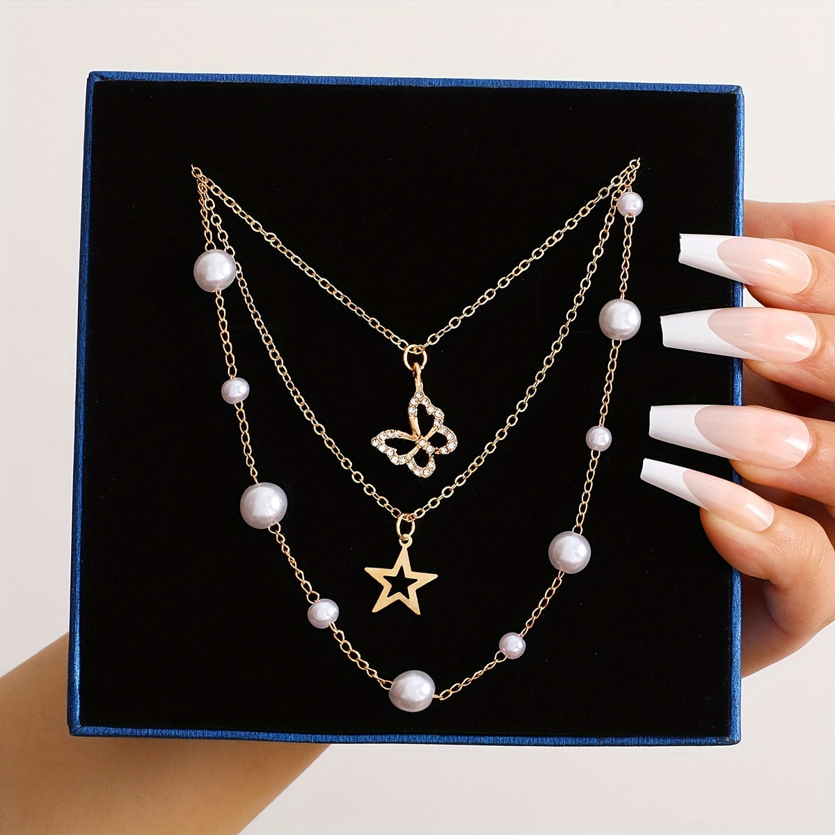 Set of 11 pieces featuring faux pearl and rhinestone star, butterfly, and heart necklaces for women. This fashion stacking jewelry set is perfect for daily wear, dates, holidays, and parties. Ideal for adding a simple and vacation style to any outfit.