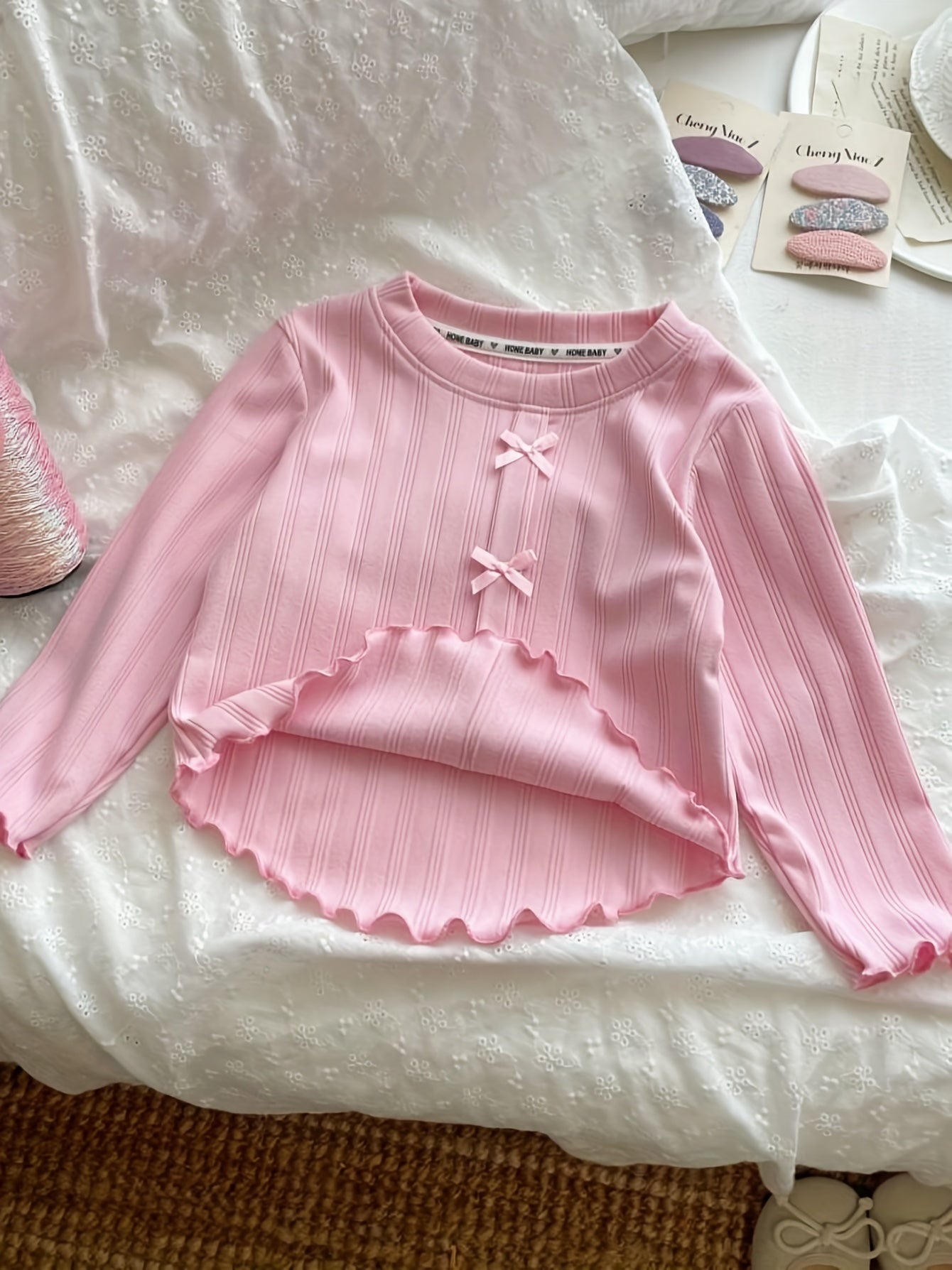 Stylish long-sleeve t-shirt with bow detail for girls, perfect for leisure and outdoor play, also makes a great gift.